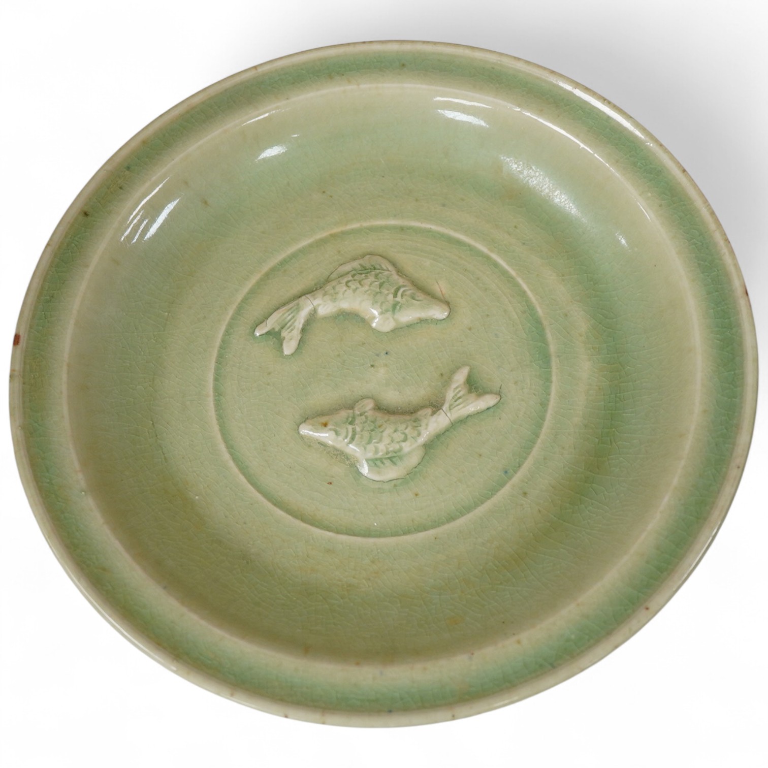 A South East Asian celadon glazed twin fish dish, 26cm diameter